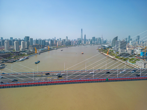 The drone aerial view of Yangpu bridge across Huangpu River in Shanghai, China.