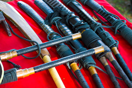 Group of ancient styled southeast asian blades and swords. Equipment of stuntmen performing historical thai show at history event in Phitsanulok organized by government as public event
