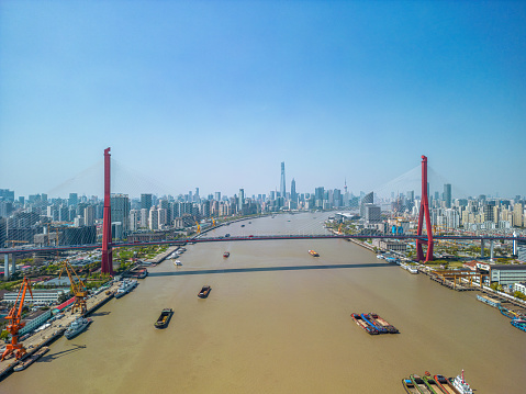 The drone aerial view of Yangpu bridge across Huangpu River in Shanghai, China.