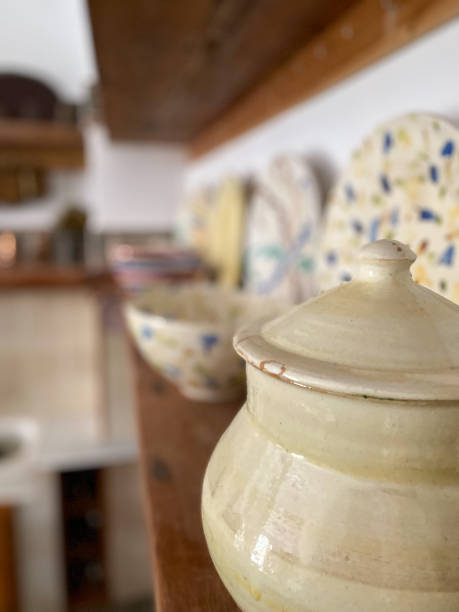 istock Wooden shelf in the kitchen with old handmade ceramic plates and bowls 1493765757