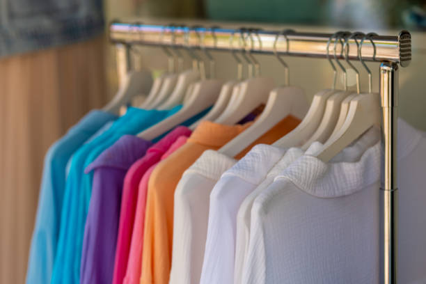 colorful dresses on clothes hooks in a fashion store