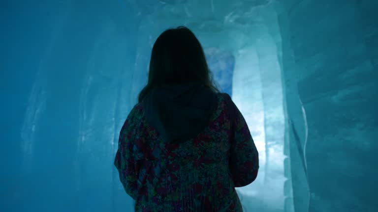 Tourist women exploring ice cave