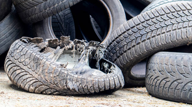 istock Garbage from a pile of black old car tires. Environmental pollution. Ecological problems. Old car tires thrown into an industrial landfill for recycling. Reuse of worn rubber tires. 1493770995