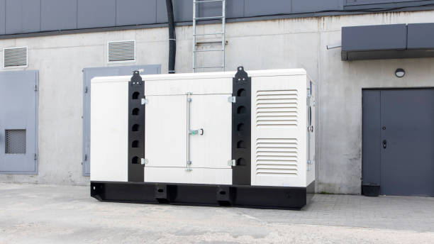 istock White auxiliary diesel generator for emergency power supply. Industrial generator connected to the control panel by a cable wire. Backup power supply of the generator. 1493771088