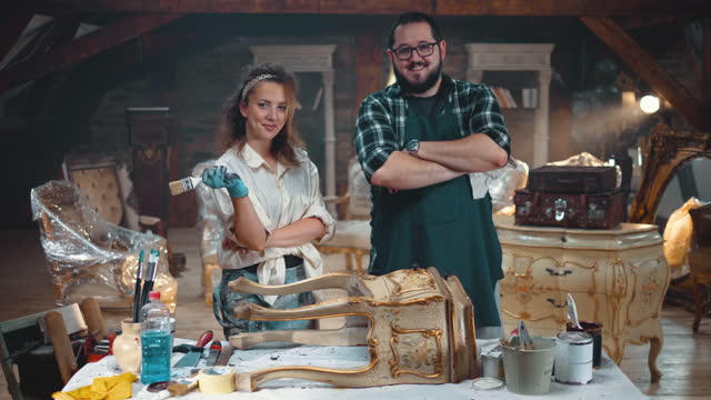 Portrait of smiling couple standing in an antique shop store and looking at camera