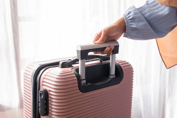 istock Unrecognizable woman holding a travel suitcase handle 1493777717