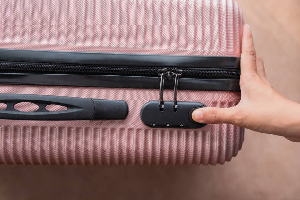 istock Unrecognizable woman unlocking travel suitcase 1493777754