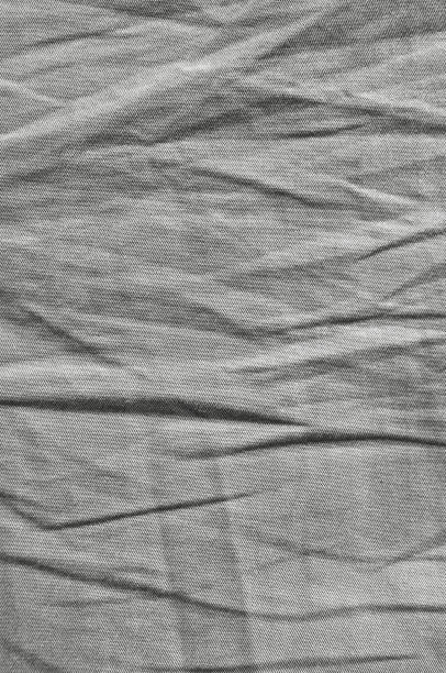 Dark white black grey natural light cotton linen chinos texture, detailed macro closeup, rustic crumpled vintage textured fabric swatch, diagonal wrinkled twill jeans canvas pattern, vertical copy space background