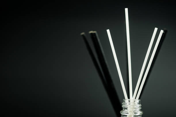 istock Fragrance diffuser perfume freshener with black and white sticks on a black background with space for text. 1493779790