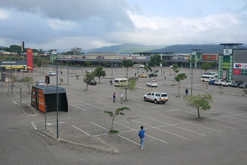 Lowveld Mall, Hazyview – 04.12.2023: African men loiter in an almost empty car park