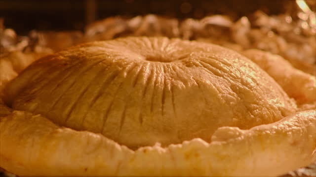 Cooking process of puff pastry meat pie inside home kitchen oven, timelapse