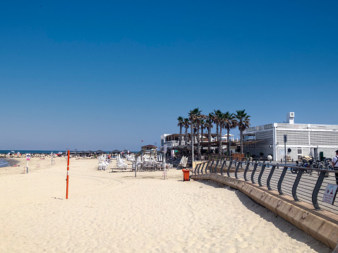 scenic beach with promenade in Tel Aviv in midday heat