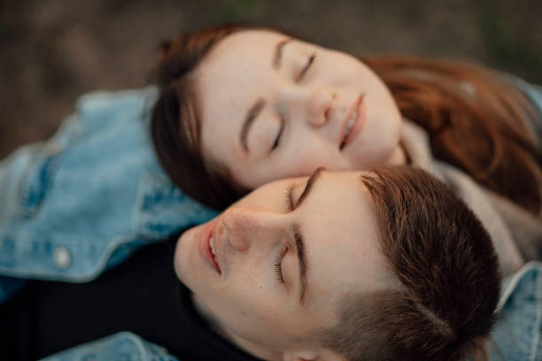 happy young loving young couple relaxing with eyes closed, head on shoulder - human face heterosexual couple women men imagens e fotografias de stock