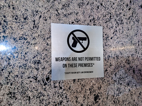 No guns or weapons allowed sign placed on a building