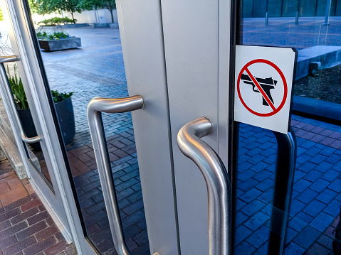 No guns or weapons allowed sign placed on a building