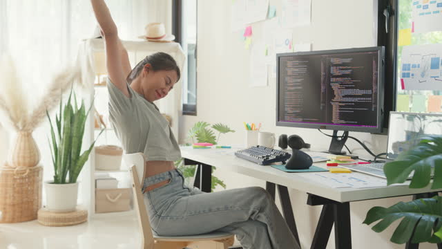 Young girl development programmer overwork relax stretch muscle painful from office syndrome solve problem coding program fix database on computer on table in workplace at house office.