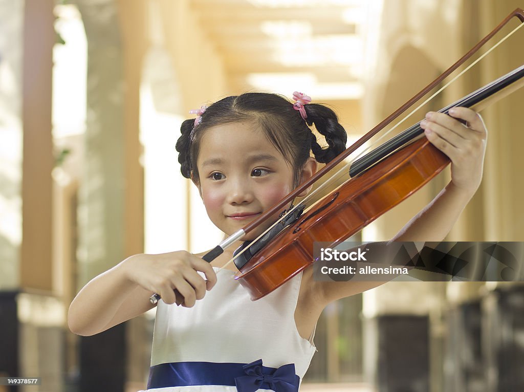 violin girl a Chinese girl playing violin Girls Stock Photo
