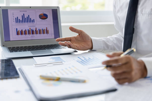 istock Modern male businessman or marketing data analyst working with laptop and graph data in office. 1493785869