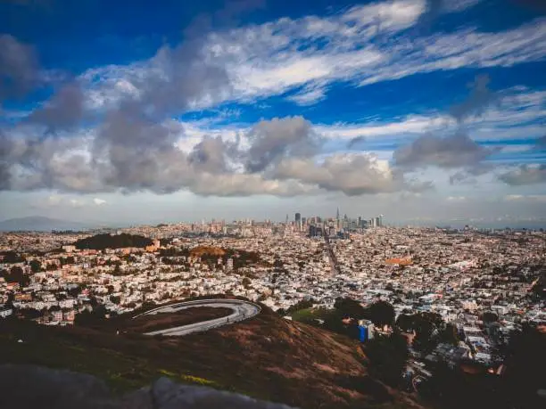 Aerial view of San Francisco cityscape from the top of a mountain, featuring iconic buildings and landmarks