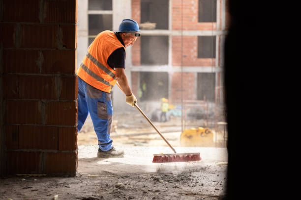 istock Unrecognizable mid-adult construction worker using broom to clean the dust on construction site 1493790003