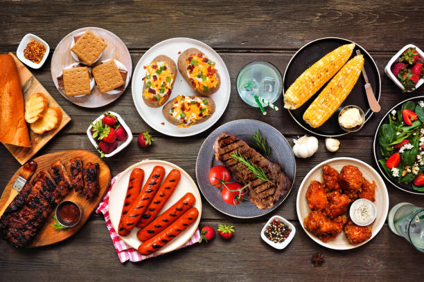 istock Summer BBQ food table scene over a dark wood background 1493790495