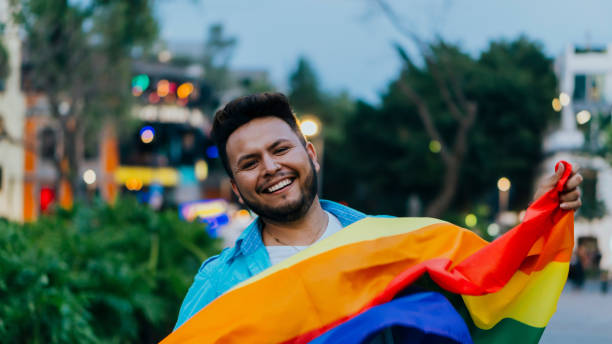 istock Bearded Latino man smiling with the LGBT flag. 1493797748