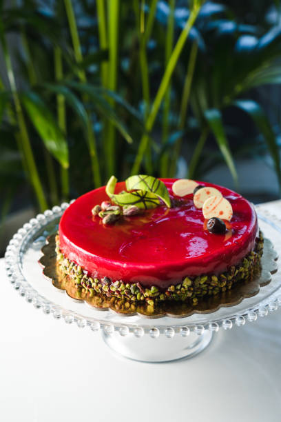 istock Red mirror half glazed cake with pistachio and chocolate on top 1493800869