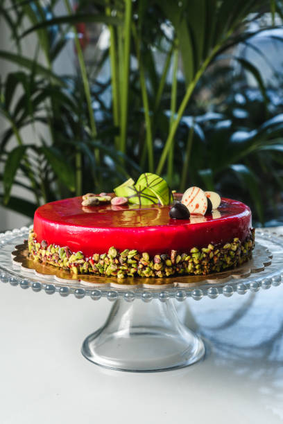 istock Red mirror half glazed cake with pistachio and chocolate on top 1493800941