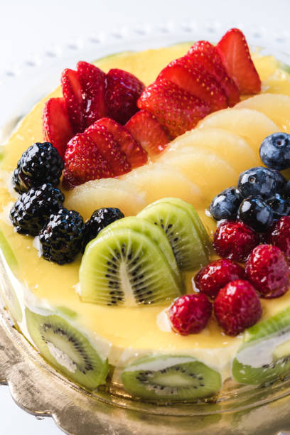 istock Short crust pastry and sponge cake filled with cream, covered with mixed fruit and apricot glaze 1493801606