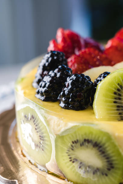 istock Short crust pastry and sponge cake filled with cream, covered with mixed fruit and apricot glaze 1493801907