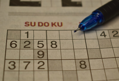 A closeup picture of Sudoku game with a pen nib on it. It was first published in a french newspaper as a numerical puzzle.
