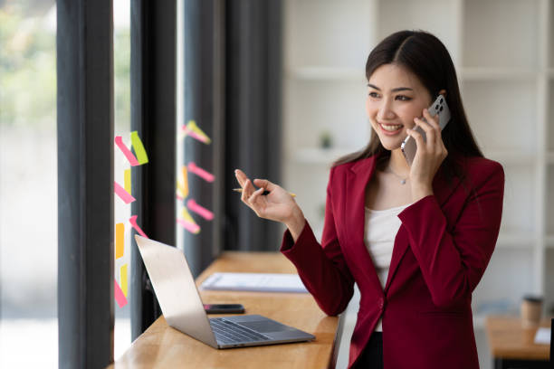 istock Young professional businesswoman using smartphone, having a phone call with her customer in the meeting room. 1493802725