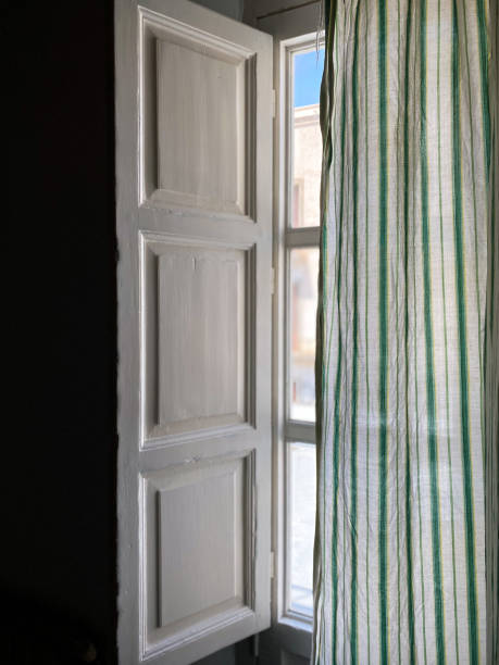 istock Rustic window at sunrise with handmade antique fabric hanging curtains 1493806173