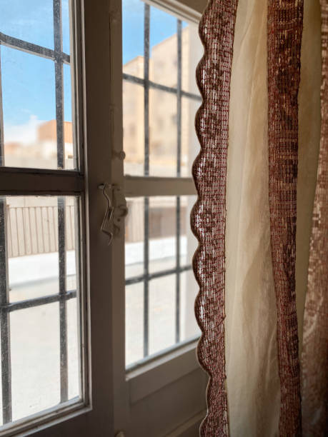 istock Rustic window at sunrise with handmade antique fabric hanging curtains 1493806182