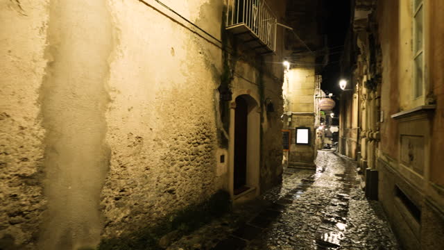 Charming narrow street of an Italian town on a rainy night