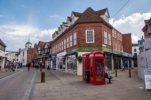 Stratford-upon-Avon, UK - 18 July 2012: Brick houses with shops and a cobbled street in the center of the city.