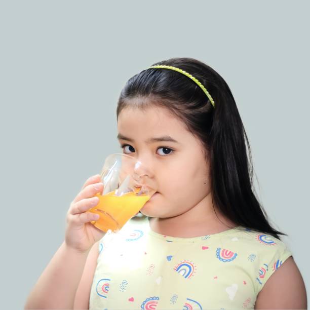 istock Girl Drinking Orange juice Stock Shoot 1493823021