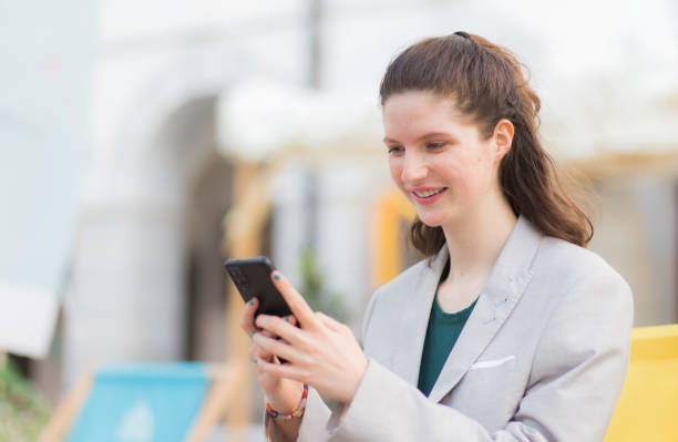 istock Happy woman reading message in shopping mall 1493826114