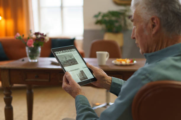 istock Senior man reading news in digital tablet. 1493826411