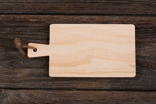 Wood cutting board  on wooden table, top view