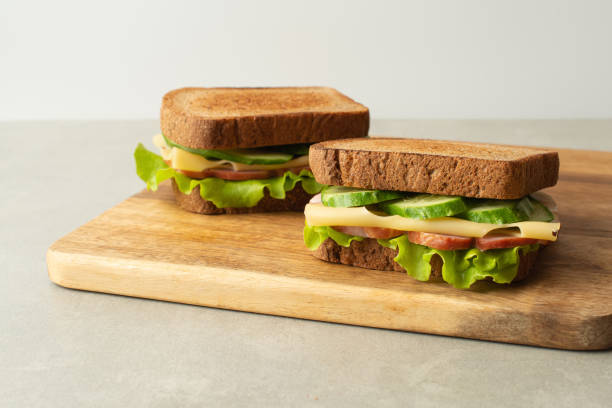 istock sandwich with meat, cheese and vegetables on a gray background 1493832512