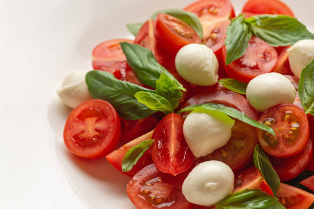 Tomatoes, mozzarella cheese, basil and oil for a fresh appetizer italian style.