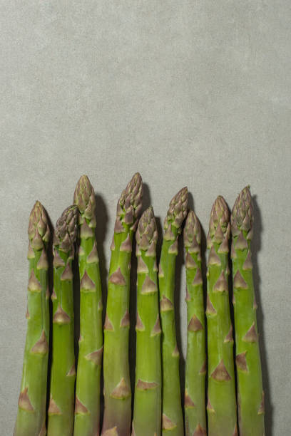 istock Asparagus on the kitchen table. Gray background. Cooking 1493834709