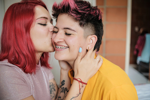 lesbian couple embracing kissing