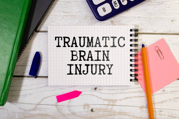 istock TBI text written in a notebook lying on a desk and a stethoscope. Medical concept. 1493846654