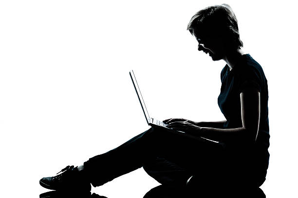 istock one young teenager  girl silhouette computer computing laptop la 149385332