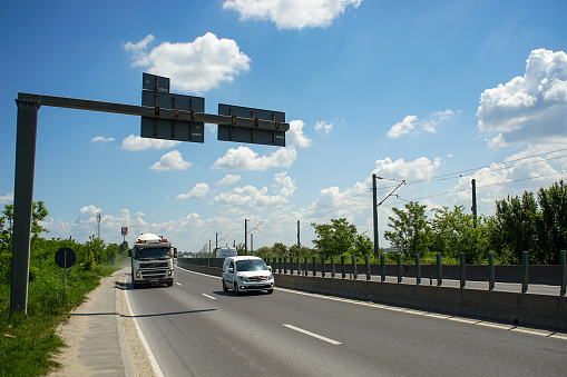 Tunari, Romania - Mai 24, 2023: Heavy trucks on traffic on the Bucharest ring road (DMCB) This image is for editorial use only.