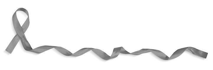 Closeup of a gray curled awareness ribbon isolated on a white background with clipping path.