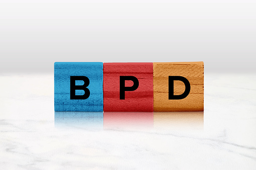 Closeup of colored wooden tiles spelling out BPD.