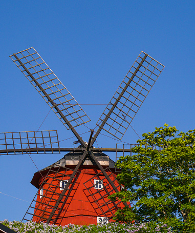 Low angle view of a windmill against blue sky